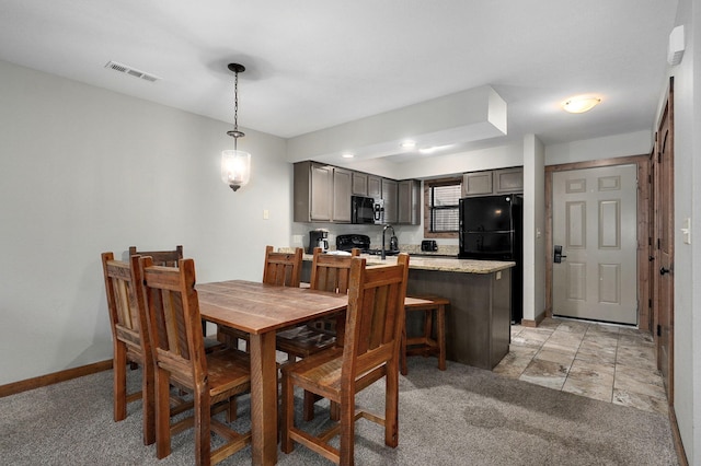 dining space featuring light colored carpet