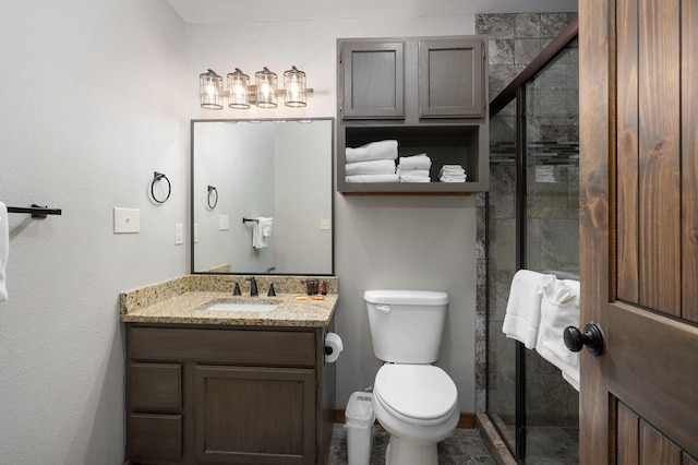 bathroom with an enclosed shower, vanity, and toilet