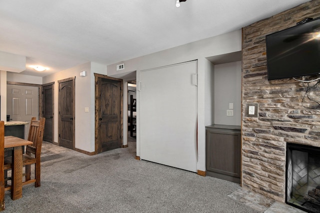 unfurnished living room featuring a fireplace and carpet flooring