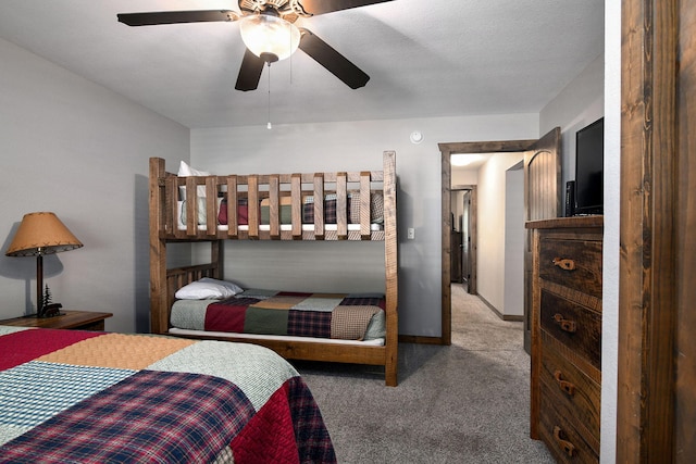 bedroom featuring a textured ceiling, ceiling fan, and light colored carpet