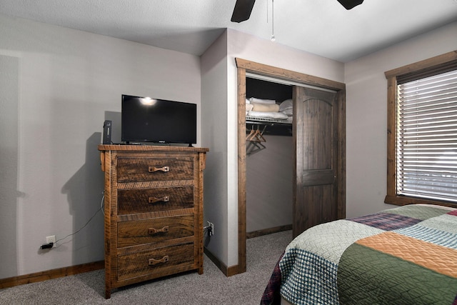 carpeted bedroom with a closet and ceiling fan