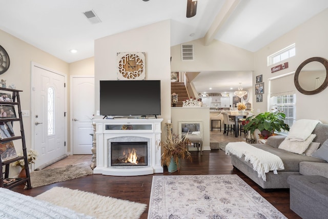 living room with lofted ceiling with beams and hardwood / wood-style floors