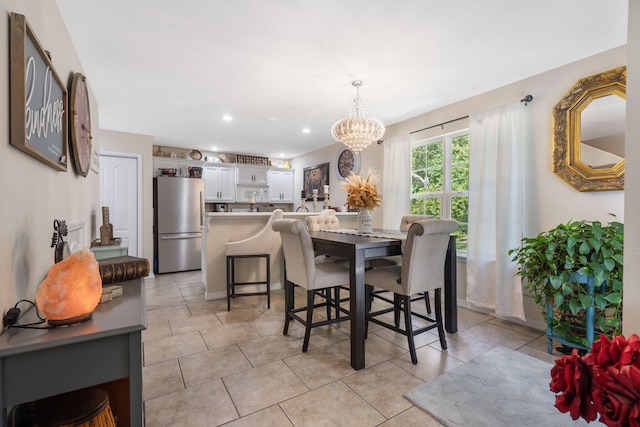 dining area featuring a chandelier and light tile patterned floors