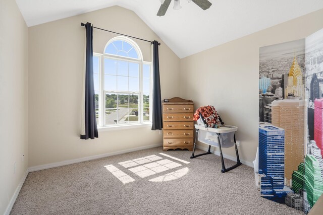 carpeted bedroom with ceiling fan and vaulted ceiling