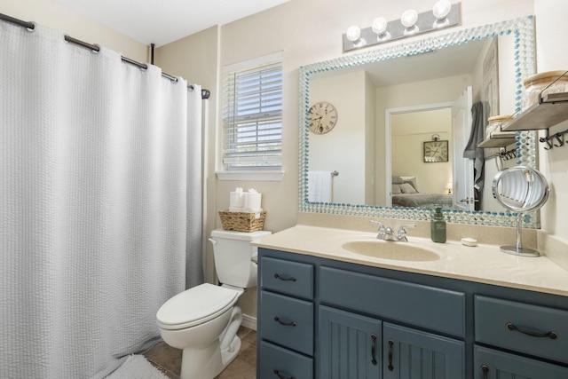 bathroom featuring toilet, tile patterned flooring, and vanity