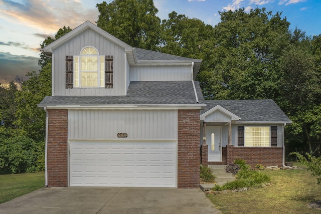 view of front of house with a garage and a yard