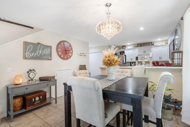 dining space with a notable chandelier and light tile patterned floors