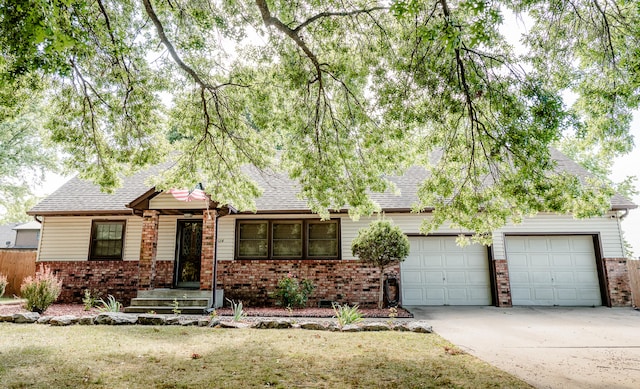 view of front of property featuring a garage and a front lawn