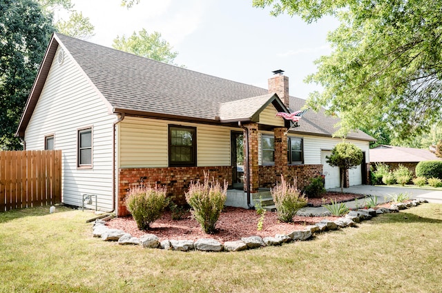 view of front of home with a garage and a front lawn