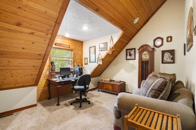 home office with wooden walls, wood ceiling, light carpet, vaulted ceiling, and a textured ceiling