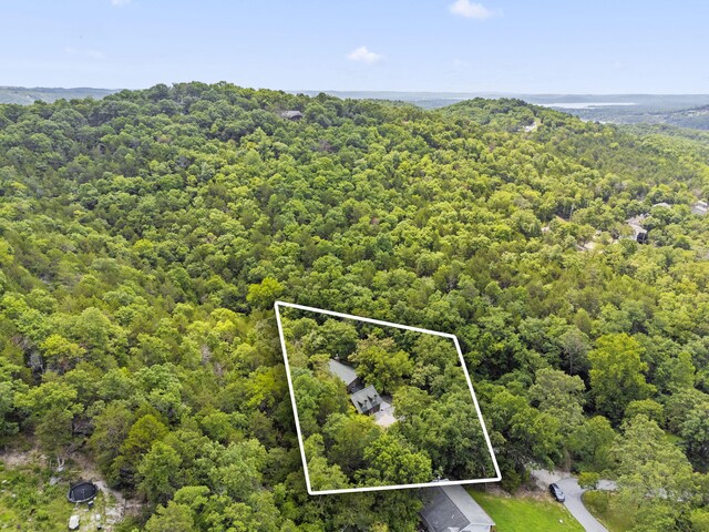 birds eye view of property with a view of trees