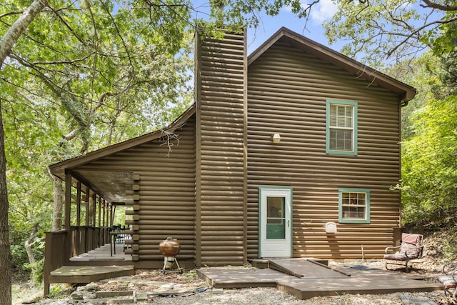 back of house with a deck