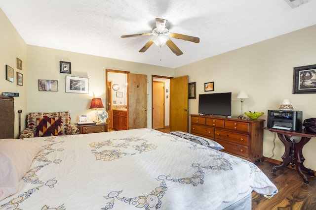 bedroom with ceiling fan, connected bathroom, and dark hardwood / wood-style flooring