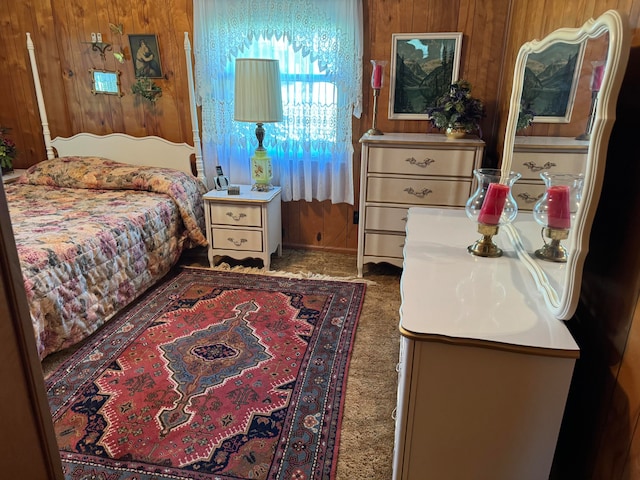 carpeted bedroom featuring wooden walls