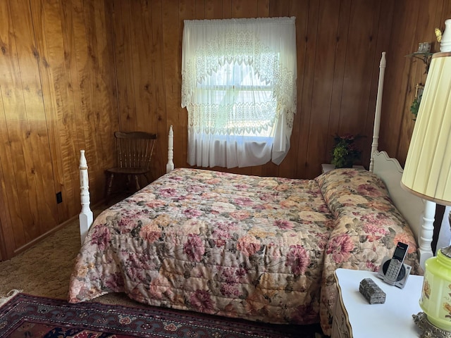 bedroom featuring carpet flooring and wood walls