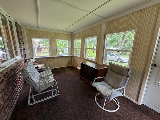 sunroom / solarium featuring vaulted ceiling