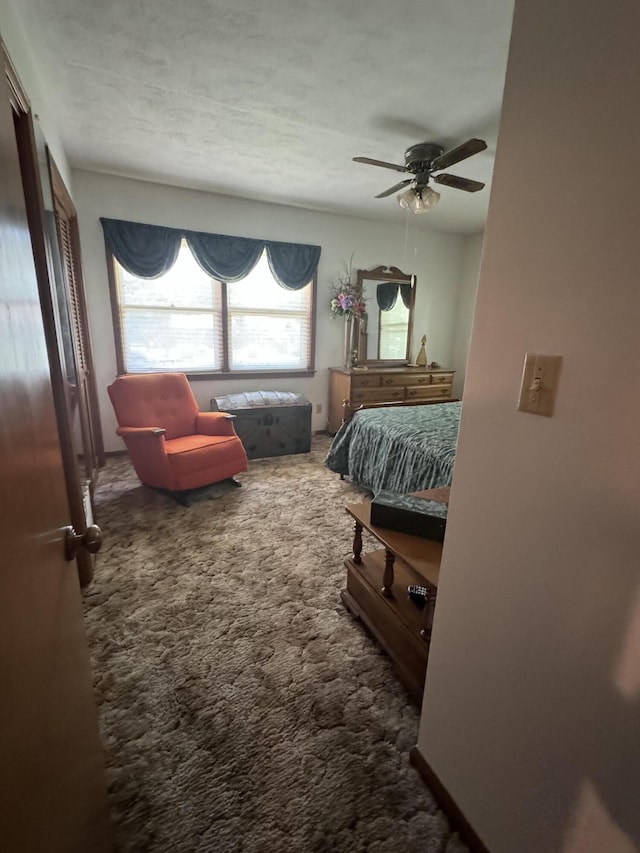 bedroom featuring a ceiling fan and carpet