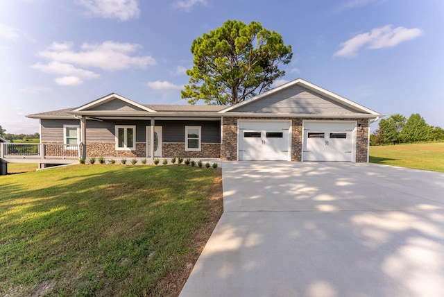 view of front of home with a front yard, a garage, and a porch