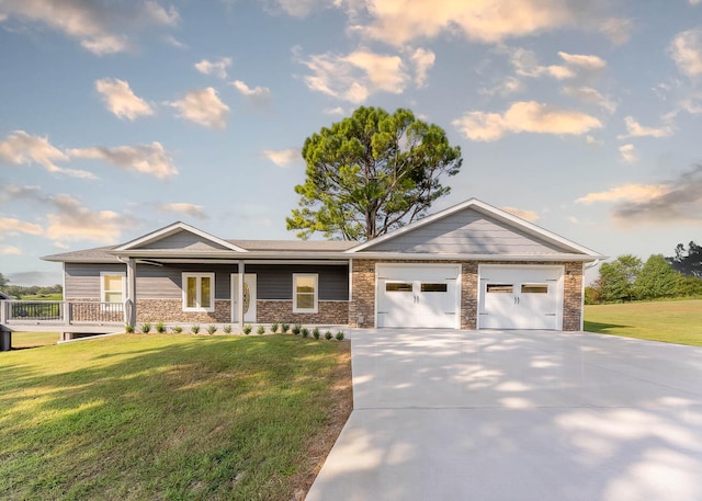 ranch-style house featuring a front yard, a garage, and a porch