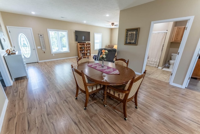 dining space featuring ceiling fan, a textured ceiling, and light hardwood / wood-style flooring