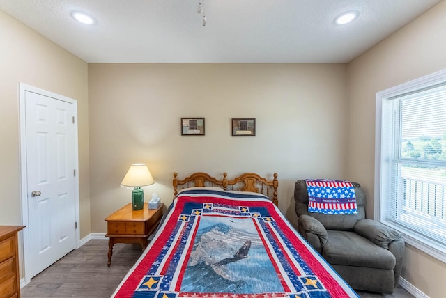 bedroom featuring wood-type flooring and a textured ceiling