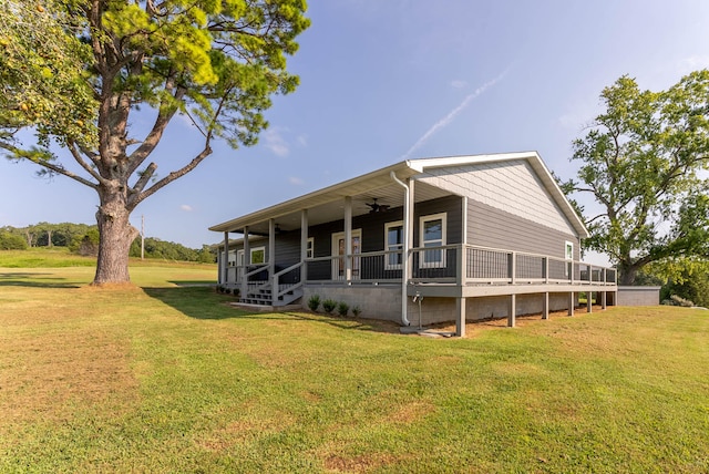 exterior space with ceiling fan and a front yard