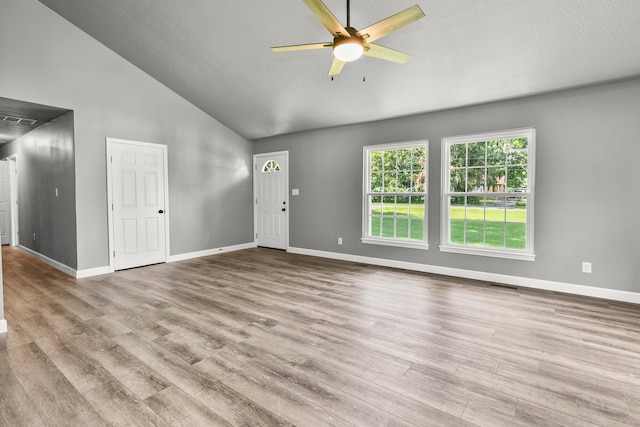 unfurnished living room with light hardwood / wood-style floors, high vaulted ceiling, and ceiling fan