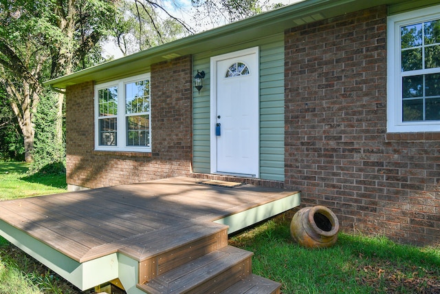 view of exterior entry with a deck