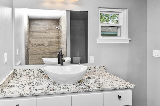 bathroom featuring vanity and a tile shower