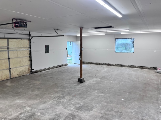 garage featuring electric panel and a garage door opener