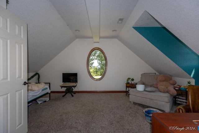 sitting room with baseboards, vaulted ceiling, a textured ceiling, and carpet