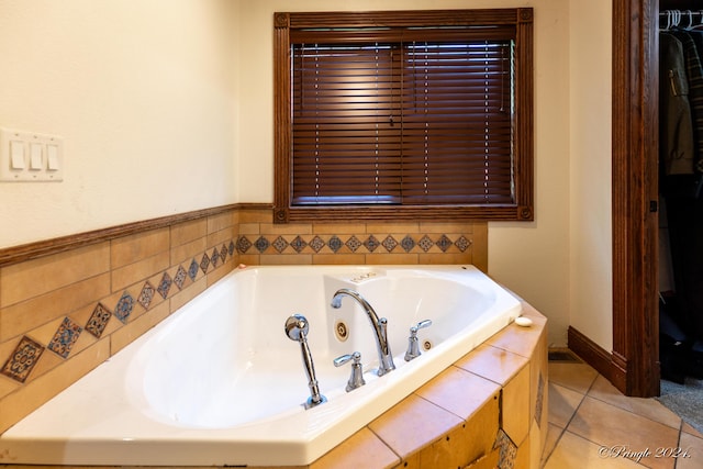 full bath with tile patterned floors and a whirlpool tub