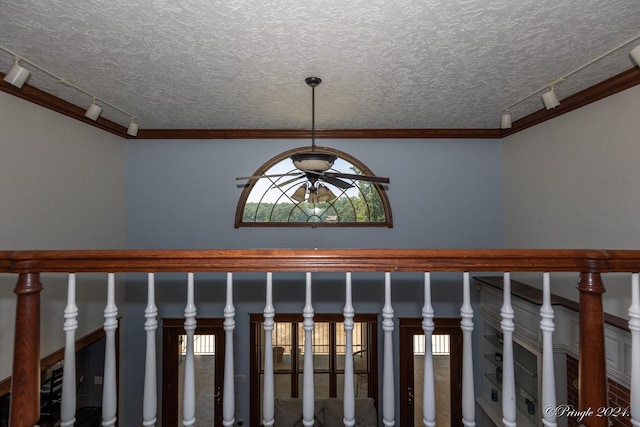 details featuring rail lighting, crown molding, a textured ceiling, and ceiling fan