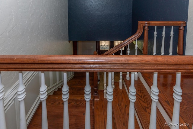 stairs featuring a textured wall