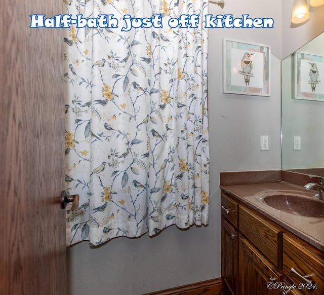 full bath with vanity and a shower with shower curtain