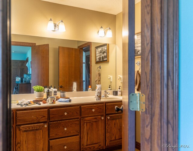 bathroom featuring a sink and double vanity