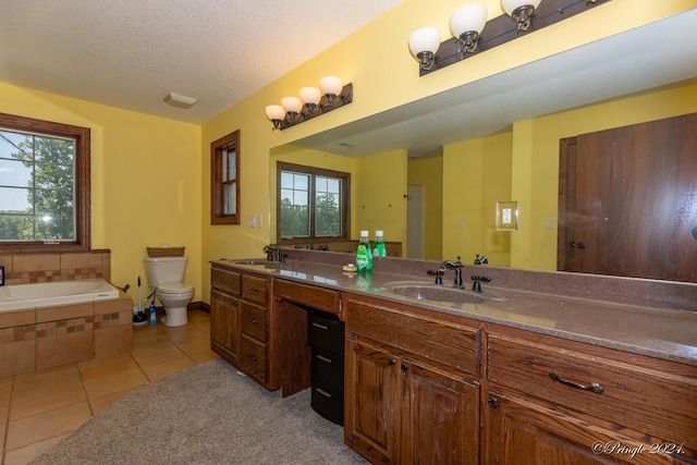 full bath with a wealth of natural light, tile patterned flooring, and a sink