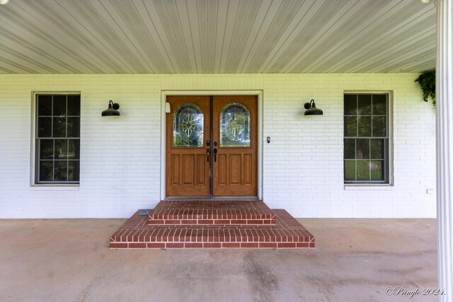 view of exterior entry with brick siding