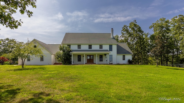 colonial-style house with a front yard