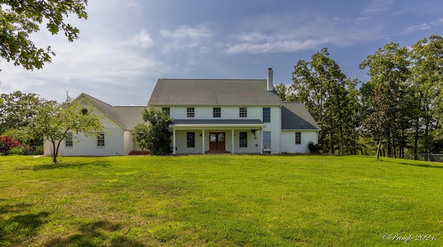 view of front of home with a porch and a front yard