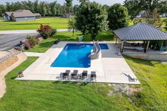 pool with a water slide, a gazebo, a yard, and a patio