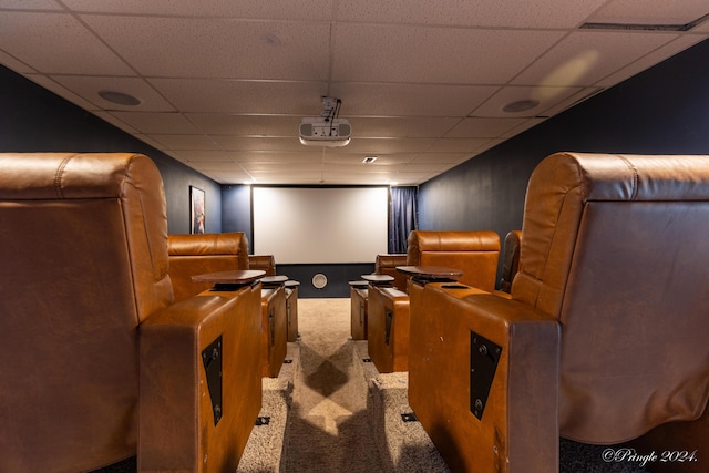 cinema room with carpet floors and a drop ceiling