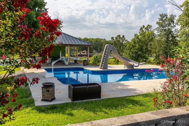 pool featuring a patio area, a water slide, and a gazebo