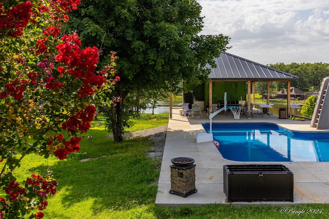 outdoor pool featuring a lawn, a gazebo, and a patio area