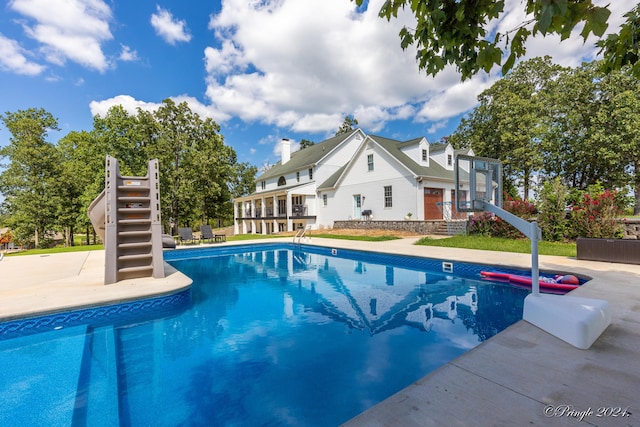 outdoor pool featuring stairway