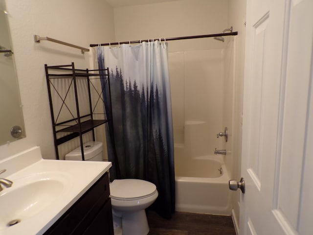 full bathroom featuring shower / tub combo, vanity, toilet, and wood finished floors