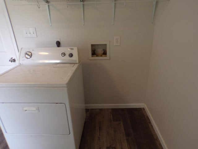 clothes washing area with laundry area, baseboards, washer / clothes dryer, and dark wood-type flooring