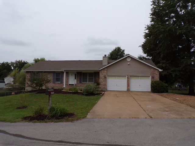 ranch-style house featuring a front lawn and a garage