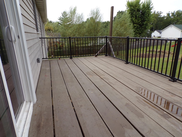 wooden terrace featuring a yard