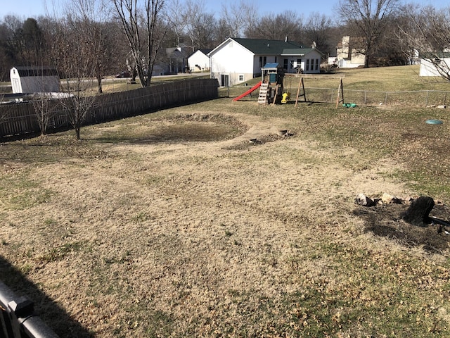 view of yard featuring fence private yard and a playground